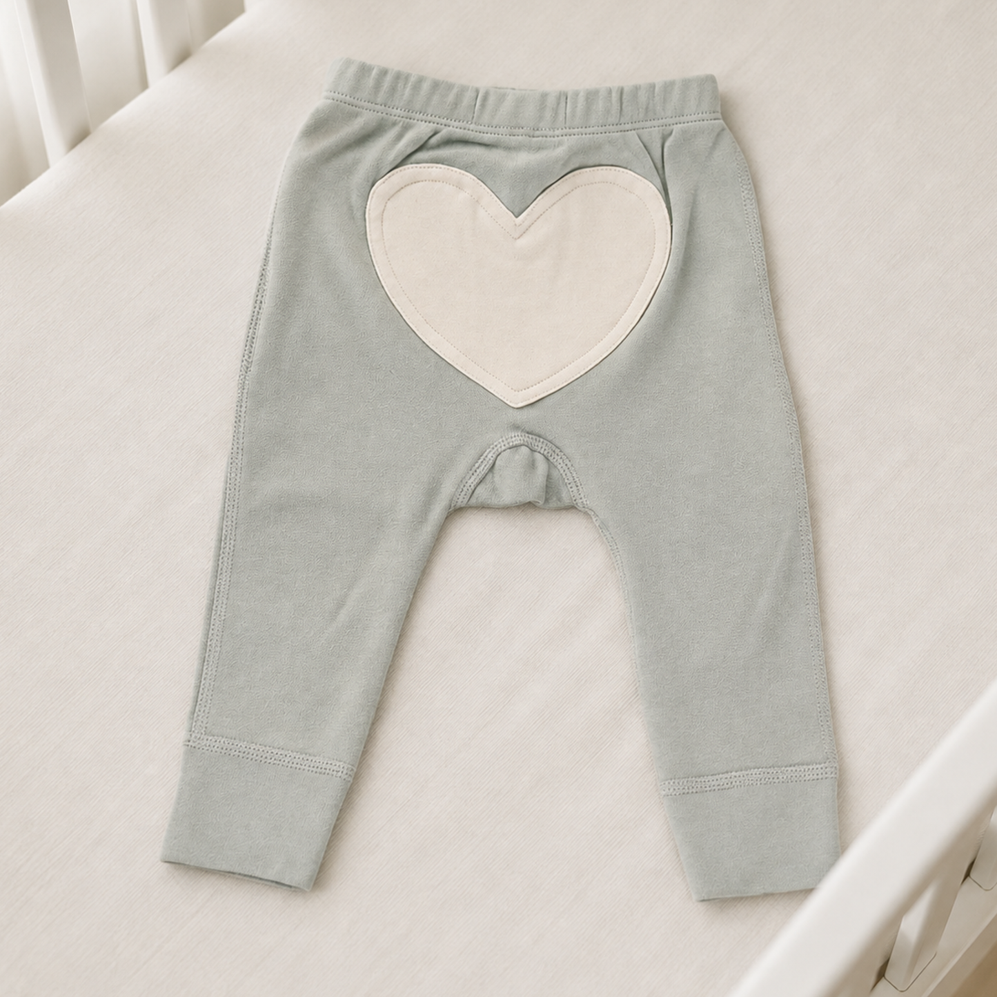 Dove grey organic cotton heart-bum baby pants 0–3 months with large cream heart appliqué