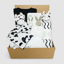 Load image into Gallery viewer, Sensory Baby Gift Hamper – black ribbed sleepsuit, monochrome muslin, cow comforter, rattle, baby wrist rattles and cellular blanket