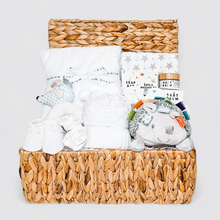 Load image into Gallery viewer, Neutral baby hamper in a basket with white blanket, hedgehog toy, muslin, and baby care items