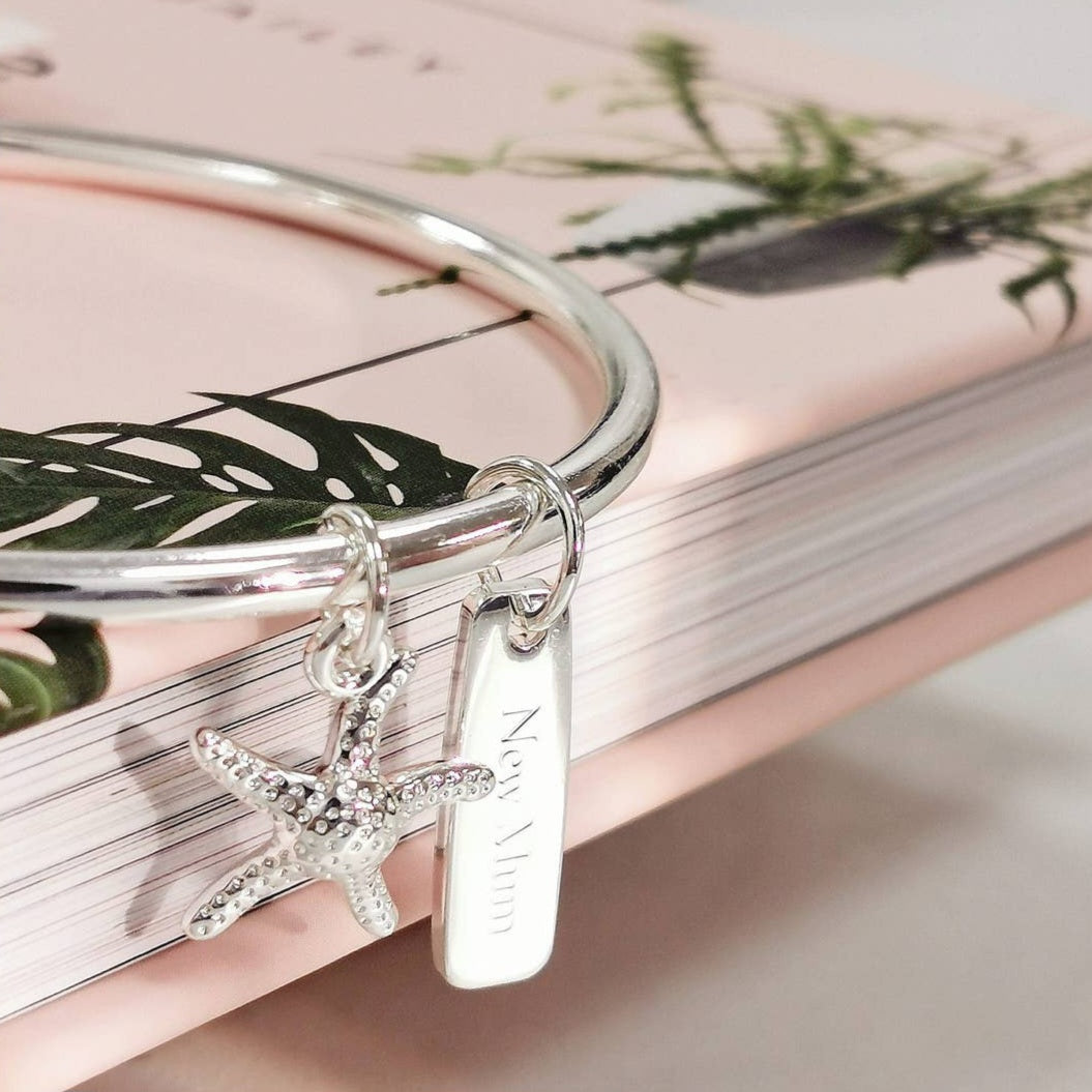 Silver bangle with starfish and rectangular charm