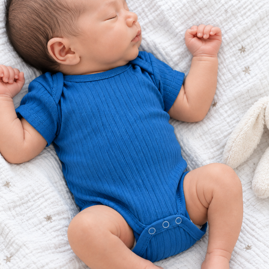 Newborn baby boy wearing an azure blue ribbed cotton bodysuit 0–3 months