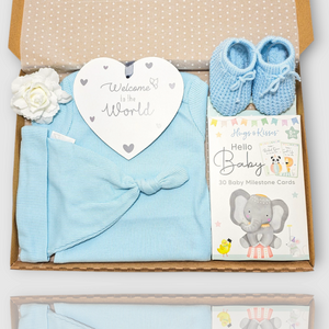 Baby blue newborn gift set with bodysuit, knotted hat, booties, milestone cards and welcome plaque