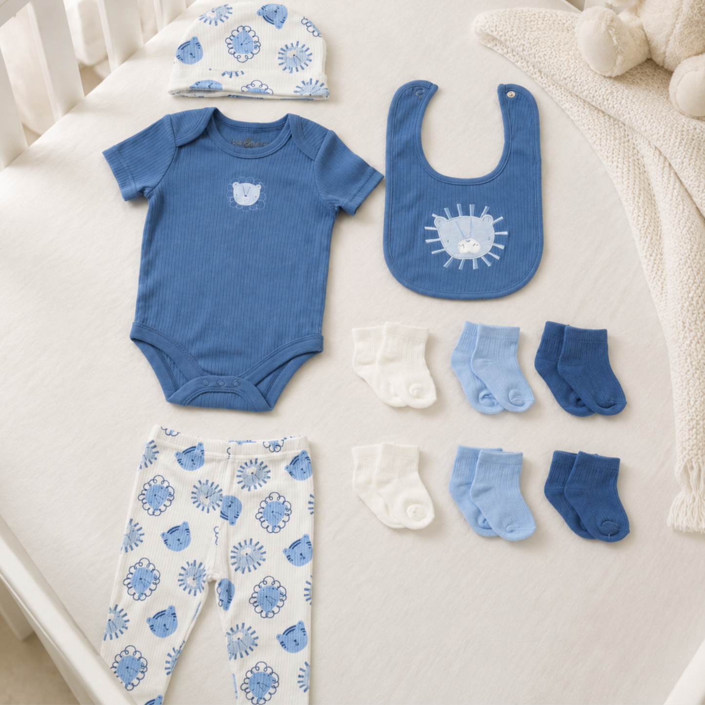 Baby boy 10 piece cotton gift set with blue bodysuit, lion print trousers, matching hat, bib and baby socks
