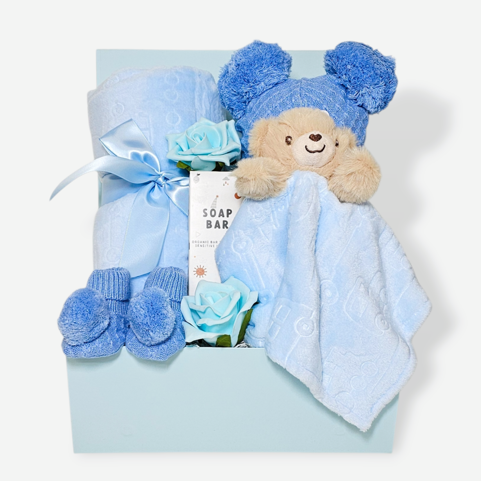 Baby boy gift box with blue bunny comforter, plush blanket, pom-pom hat and booties.