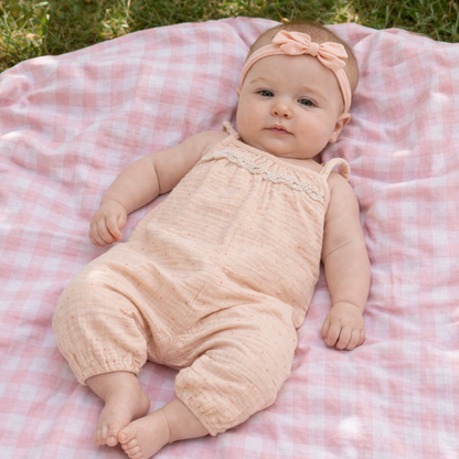 soft pink baby girl romper outfit with lace detail and matching headband for newborn baby girl