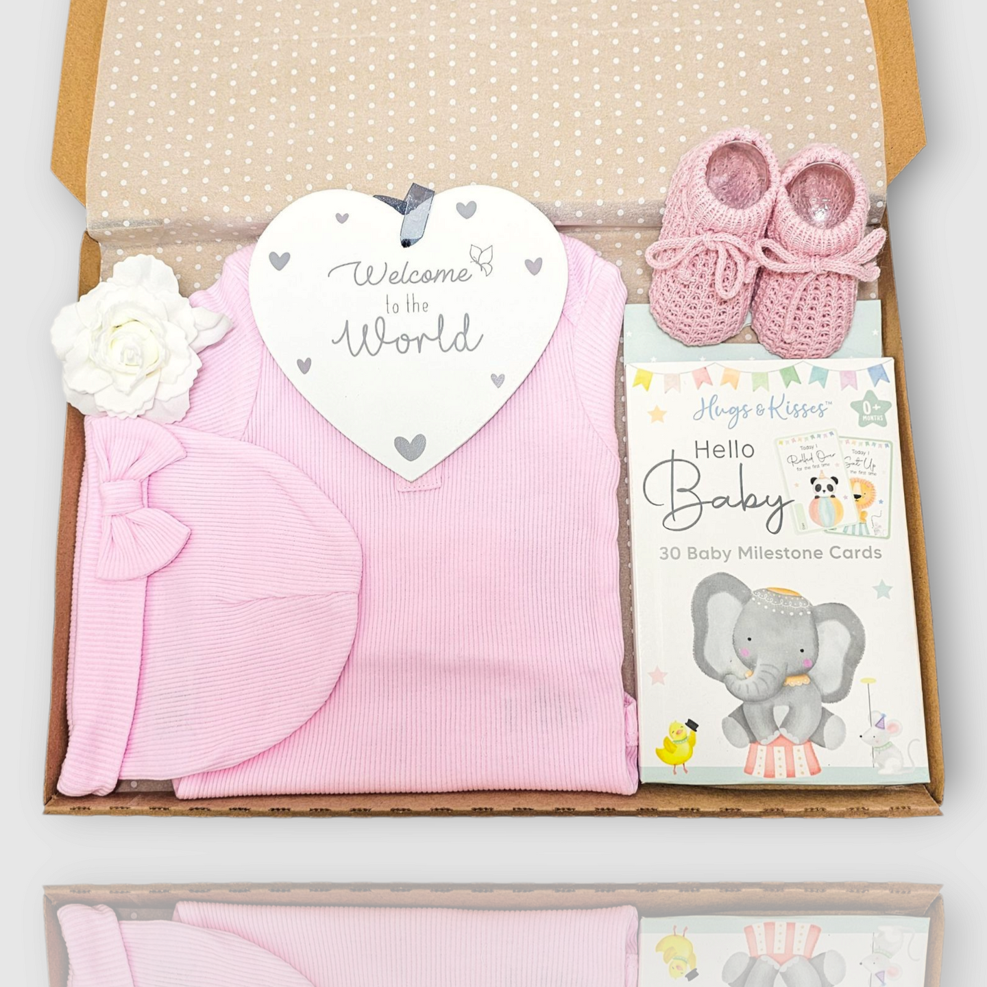 Baby pink letterbox gift with bodysuit, knotted hat, booties, milestone cards and welcome plaque

