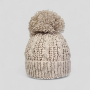 Beige knitted beanie with a pom-pom for babies