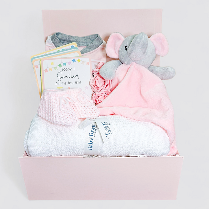 Newborn baby girl gift box packed with essentials and keepsakes