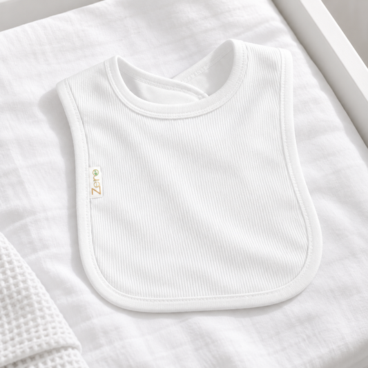 A white ribbed baby bib made of cotton, with short sleeves and a round neckline.