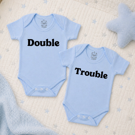 Blue cotton twin bodysuits with “Double” and “Trouble” text – newborn twins gifts