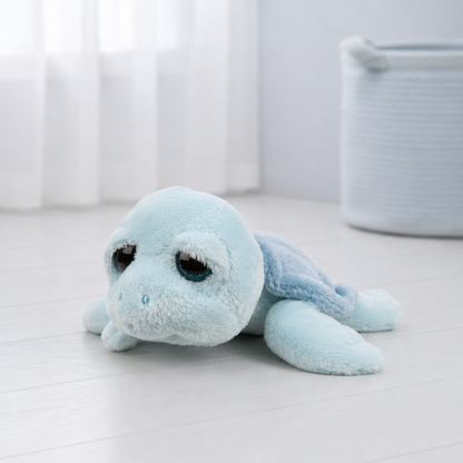 A light blue plush sea turtle toy with large dark eyes - Newborn Baby Boy Gift Bag