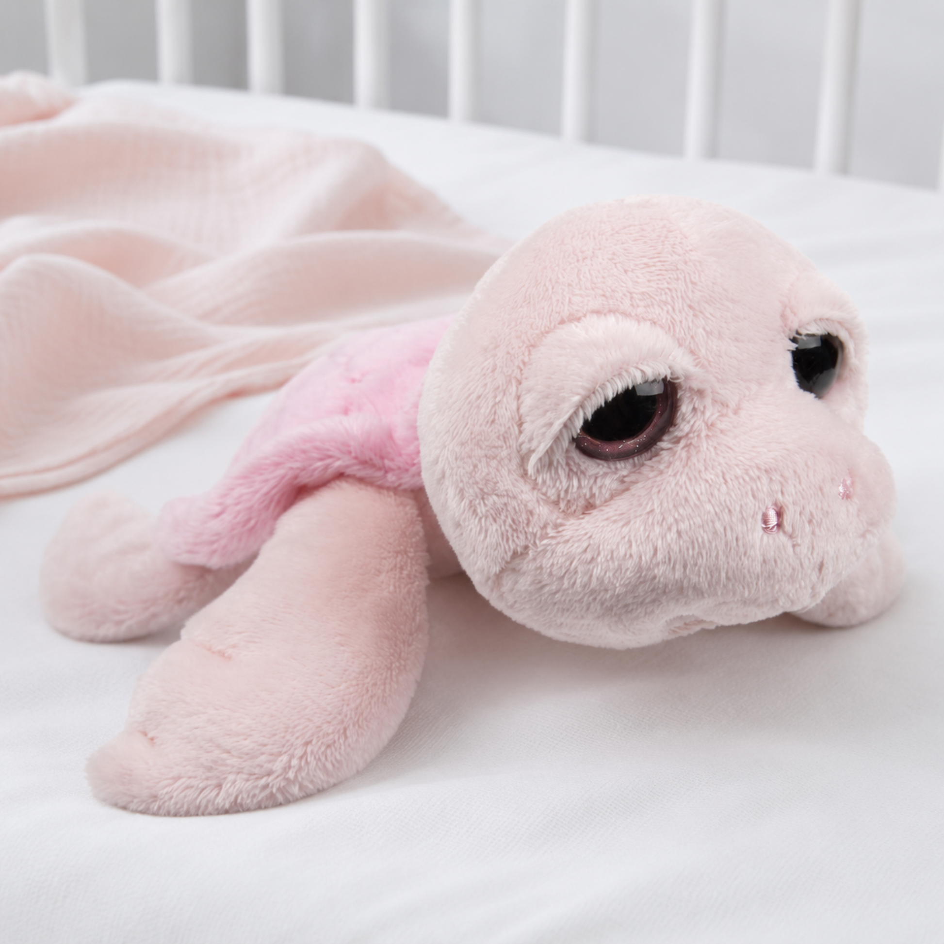 A soft pink plush sea turtle toy with large dark eyes - Baby Girl Gift Bag