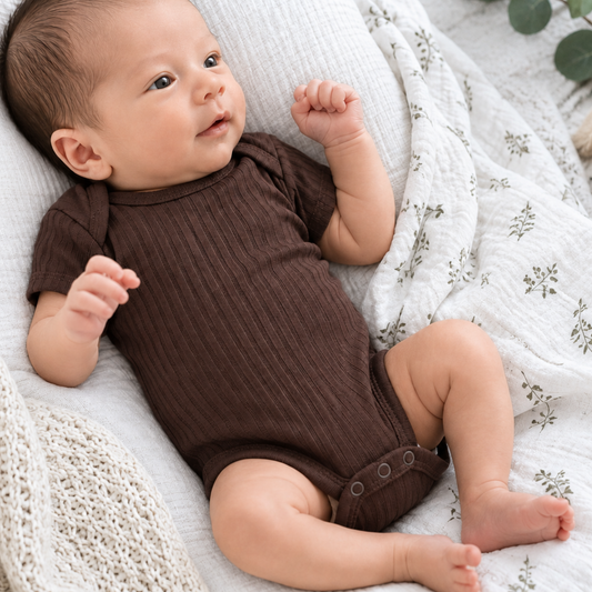 Newborn baby wearing chocolate brown ribbed 100% cotton bodysuit 0–3 months