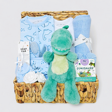 Load image into Gallery viewer, Dinosaur-themed new baby hamper for boys with blue blanket, dragon plush toy, and baby clothes 
