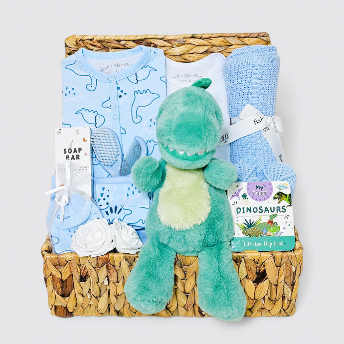 Dinosaur-themed new baby hamper for boys with blue blanket, dragon plush toy, and baby clothes 