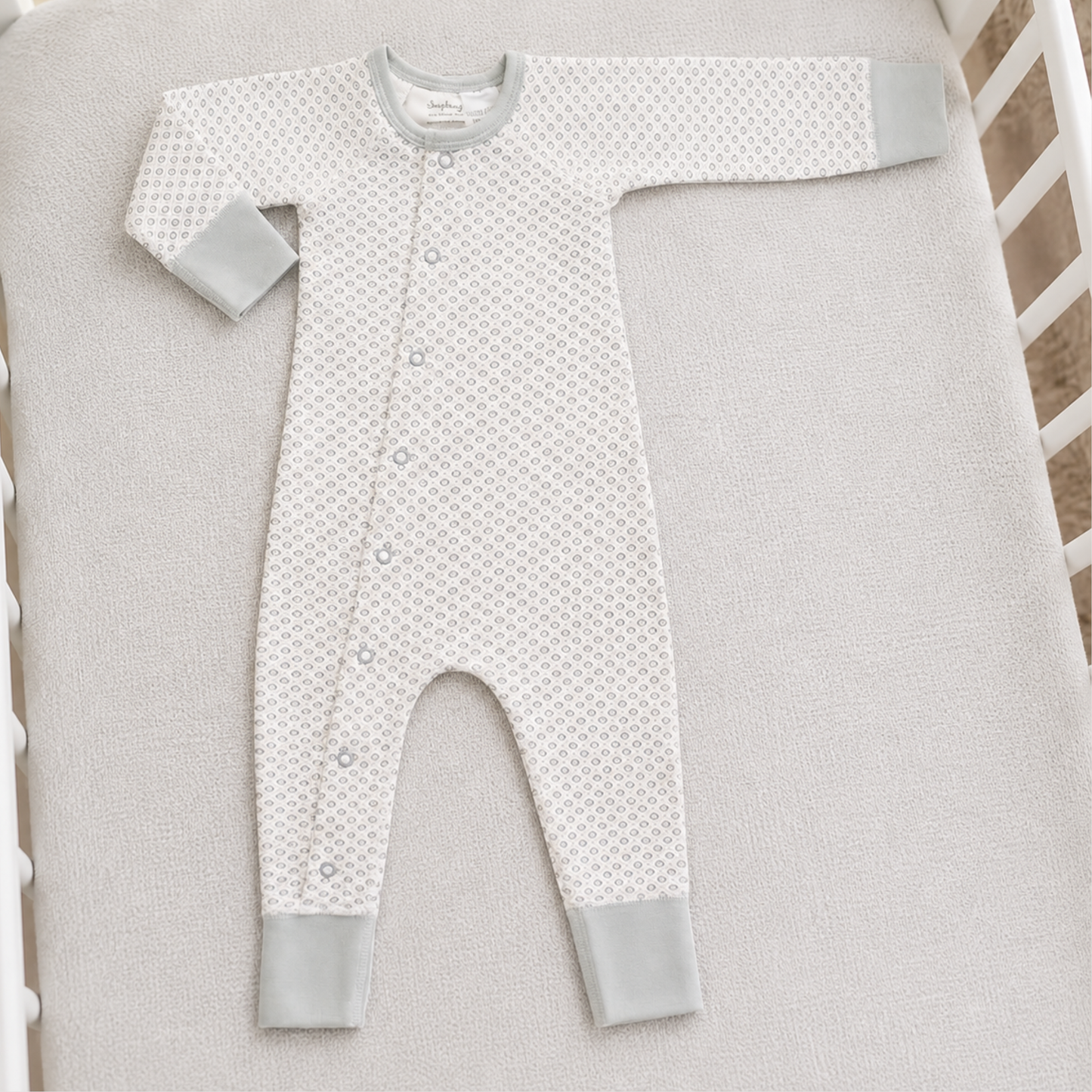 Dove grey organic cotton baby romper 0–3 months with geometric print and grey cuffs