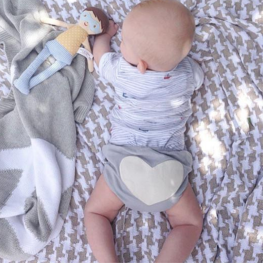 Dove grey organic cotton baby bloomers 0–3 months with cream heart appliqué on the back