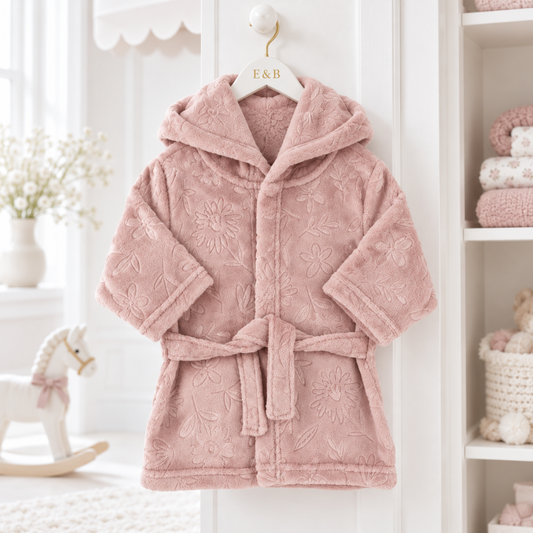 Dusty pink hooded baby dressing gown with embossed floral pattern, plush fabric and matching waist tie