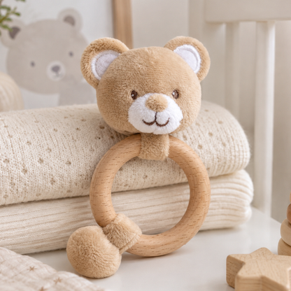 Eco-friendly teddy bear baby rattle with a natural wooden teething ring made from recycled materials.