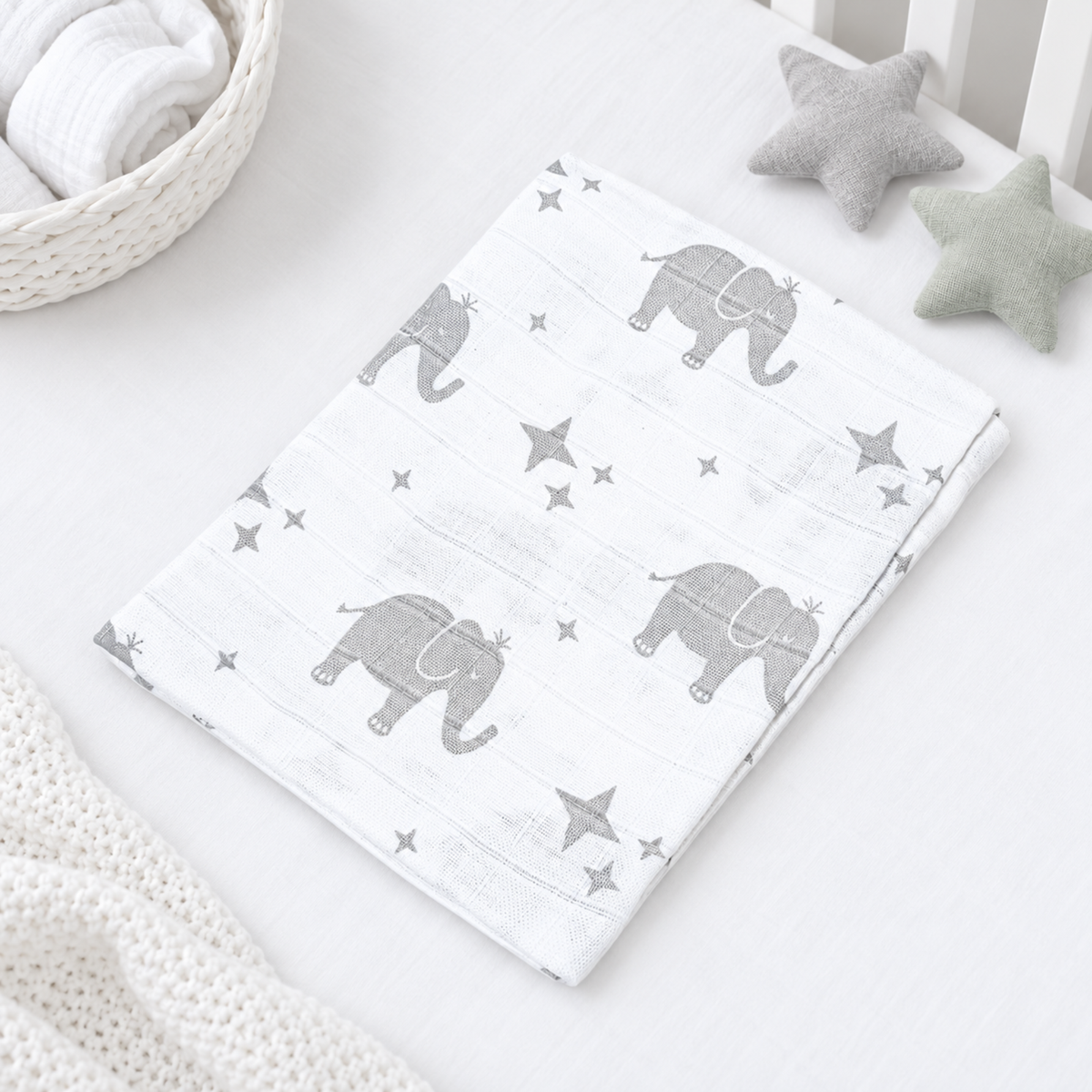 White cotton baby muslin square with grey elephant and star print, 70 × 70 cm.