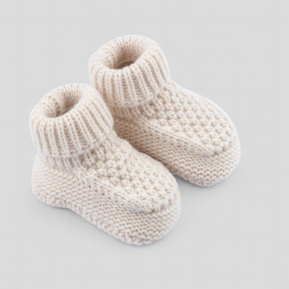 Pair of cream-colored knitted baby booties 