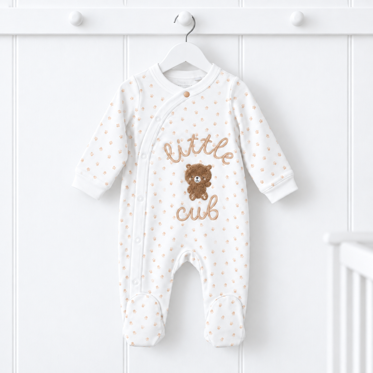 White Little Cub baby sleepsuit with beige paw prints, embroidered lettering and teddy bear appliqué, 0–3 months