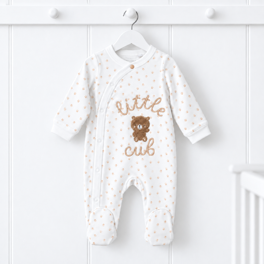 White Little Cub baby sleepsuit with beige paw prints, embroidered lettering and teddy bear appliqué, 0–3 months