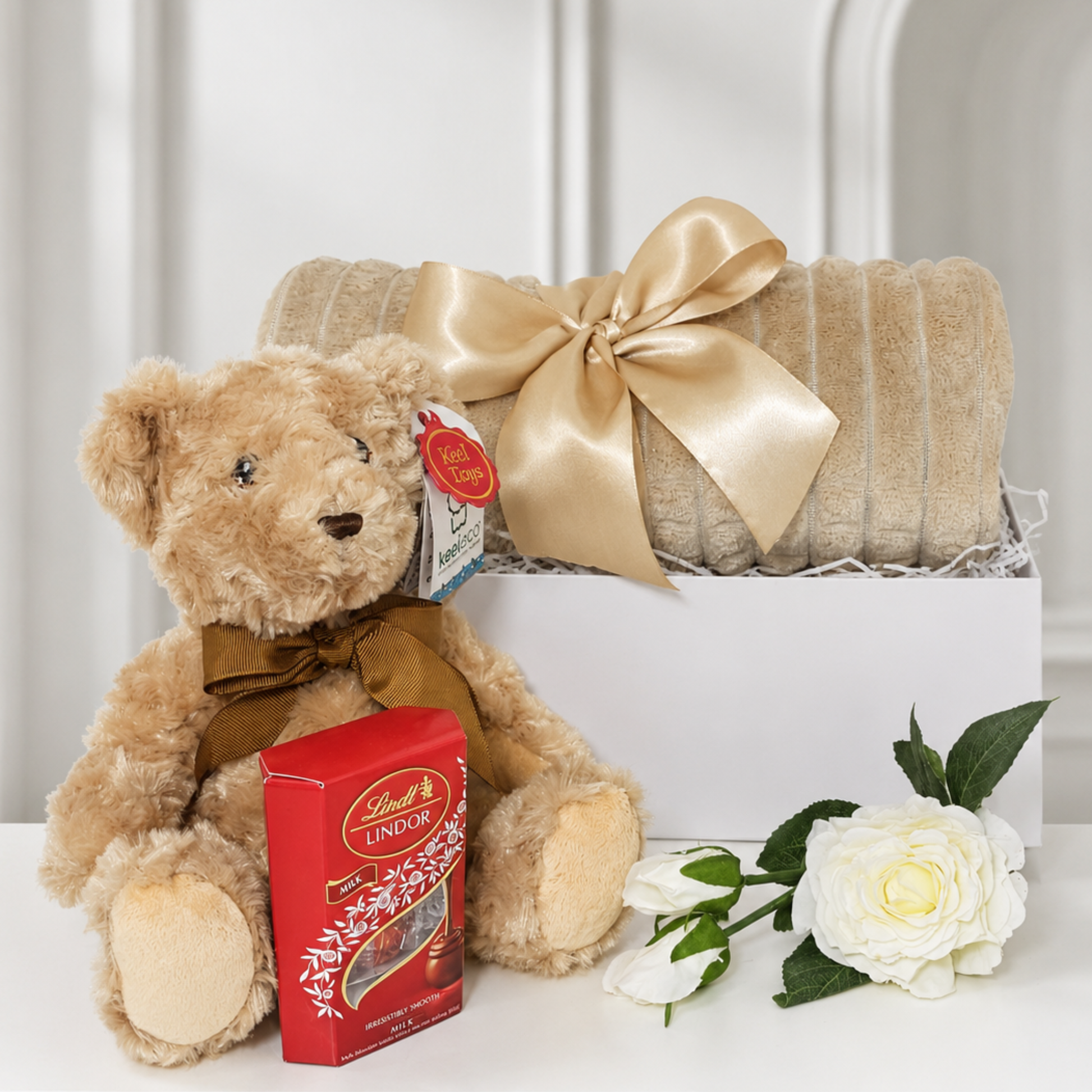 Unisex new baby gift hamper with beige plush baby blanket, puppy soft toy and Lindt chocolates – newborn and new parents gift