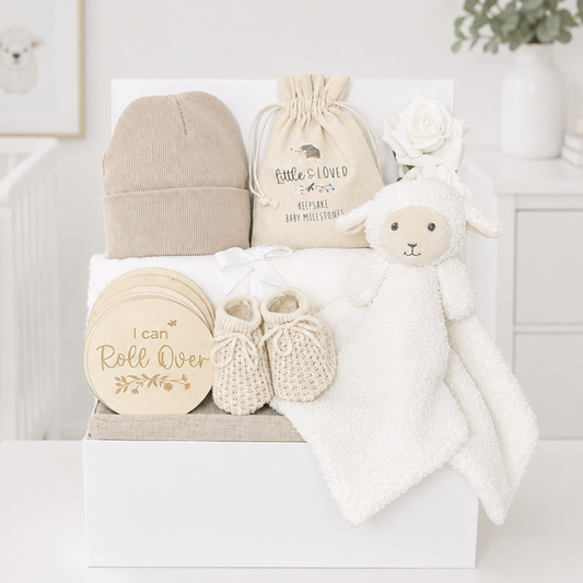 Neutral baby gift box with lamb comforter and milestone discs.