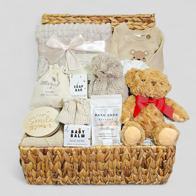 Baby boy hamper in water hyacinth basket with taupe blanket, mum’s pamper treats & plush bear.