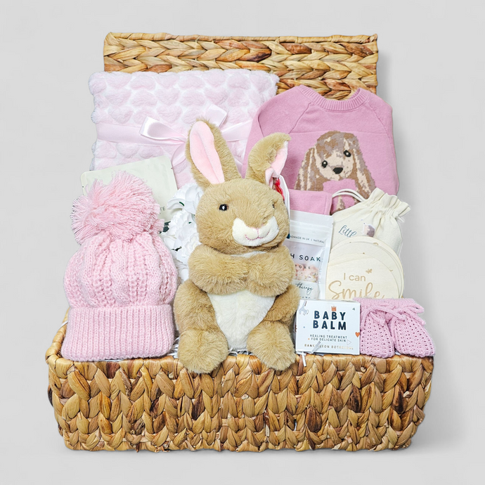 Baby hamper for girls in water hyacinth basket with dusky pink knitted set