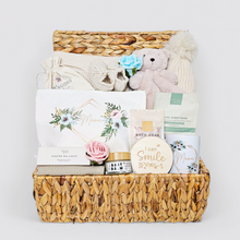 Load image into Gallery viewer, Luxury neutral new mum hamper in water hyacinth basket with baby gifts &amp; pamper gifts for mum.
