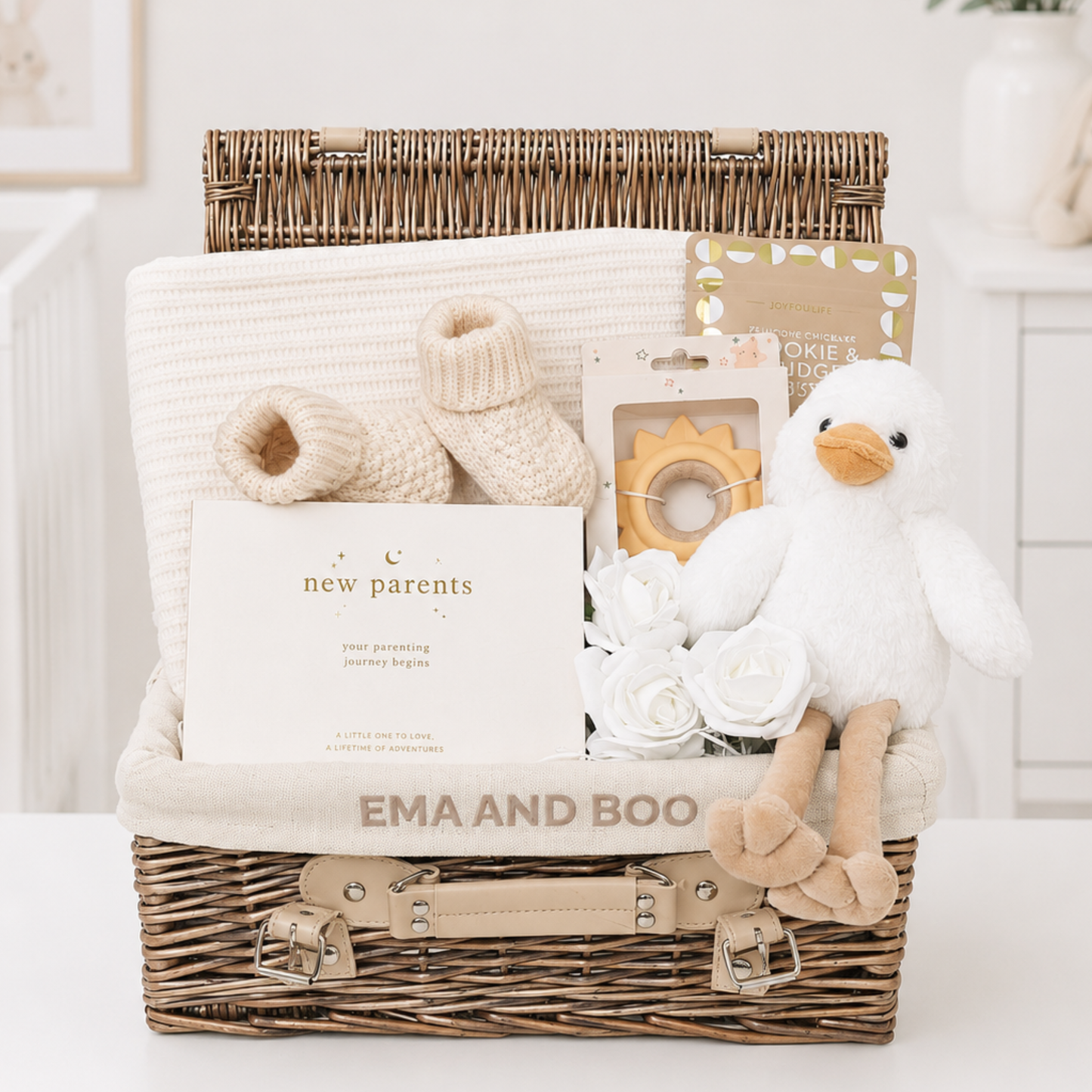 Luxury new parents gift hamper with knitted baby blanket, premium baby essentials and gifts for parents in exclusive Ema & Boo wicker hamper.