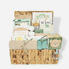 Load image into Gallery viewer, Luxury baby boy hamper in water hyacinth basket with clothing set, safari book, milestone cards, blanket, toy, and new mum pamper treats.
