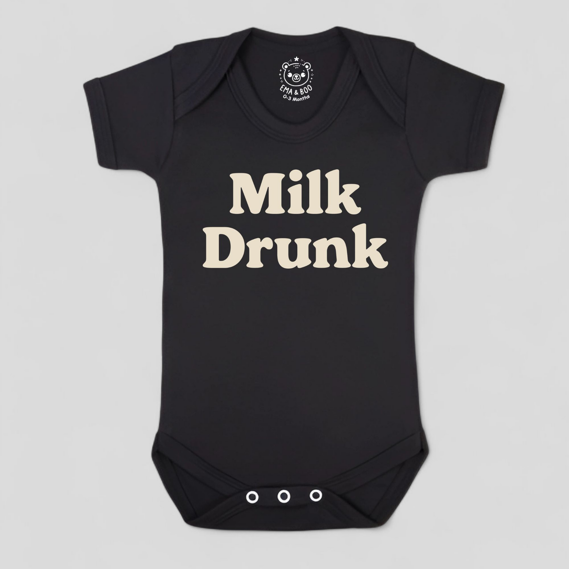 Black baby onesie with 'Milk Drunk' text 
