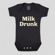 Load image into Gallery viewer, Black baby onesie with &#39;Milk Drunk&#39; text 
