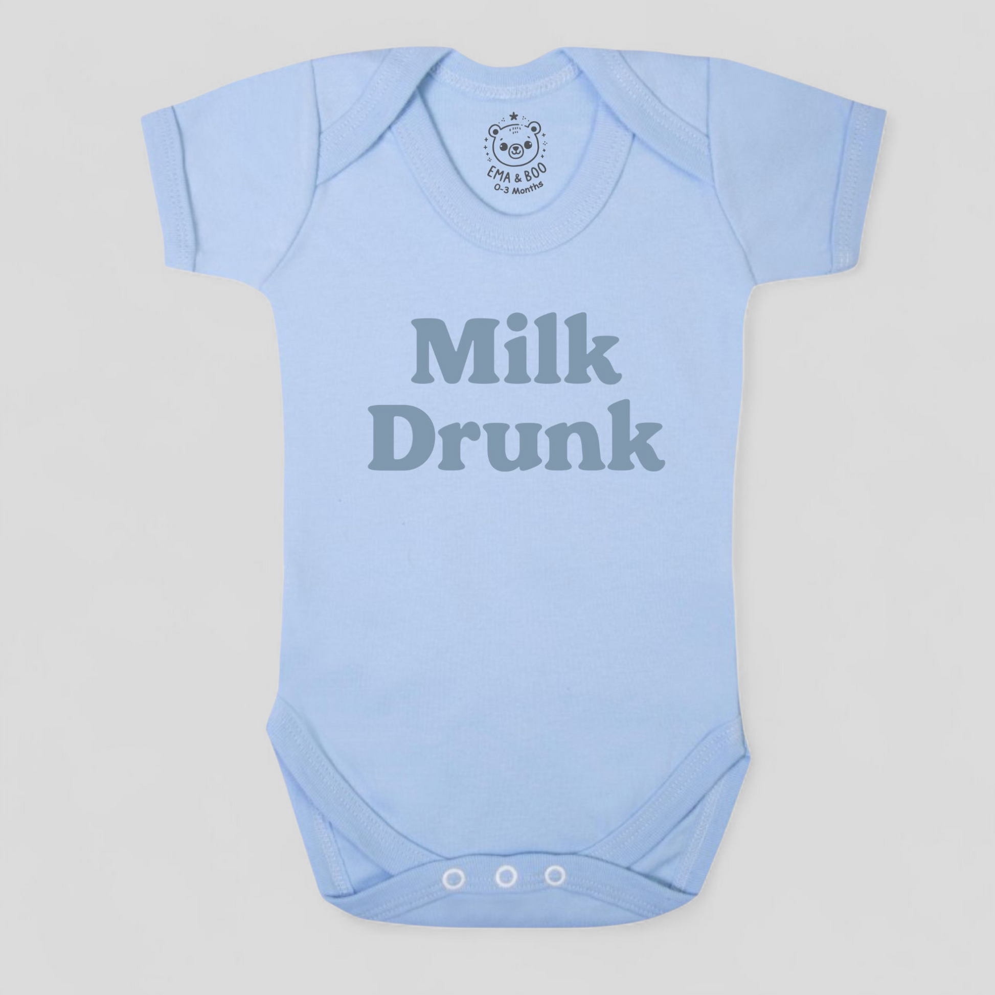 Light blue baby onesie with 'Milk Drunk' text 