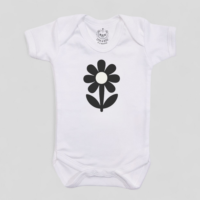 MonoCub white baby bodysuit with black flower design – newborn gift.