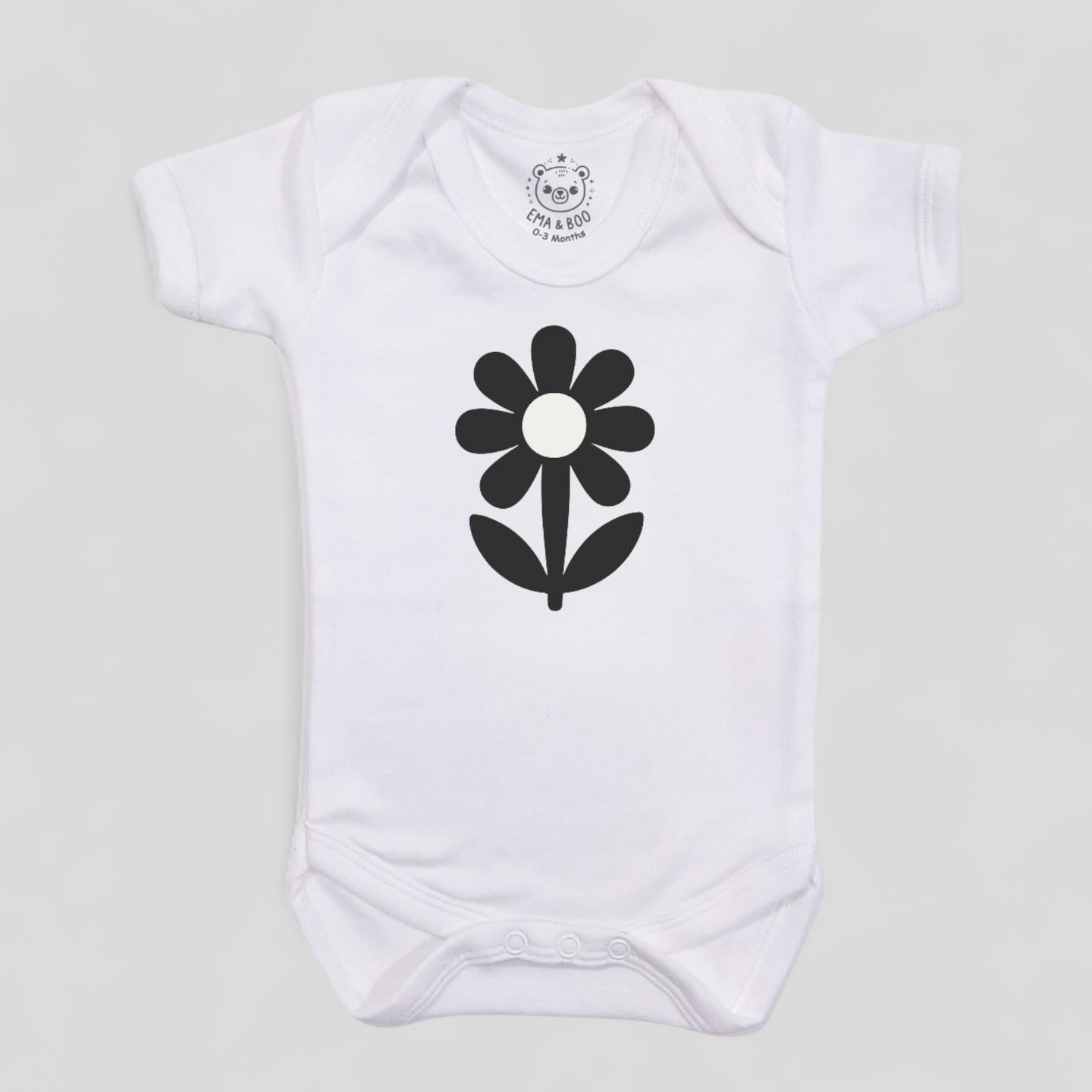 MonoCub white baby bodysuit with black flower design – newborn gift.