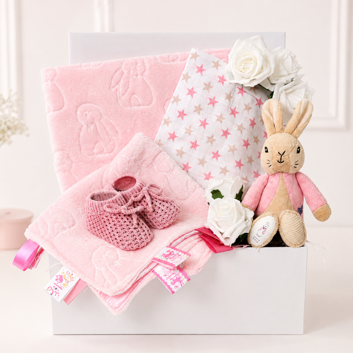 Baby girl gift box with Flopsy Bunny, pink blankets and knitted booties.