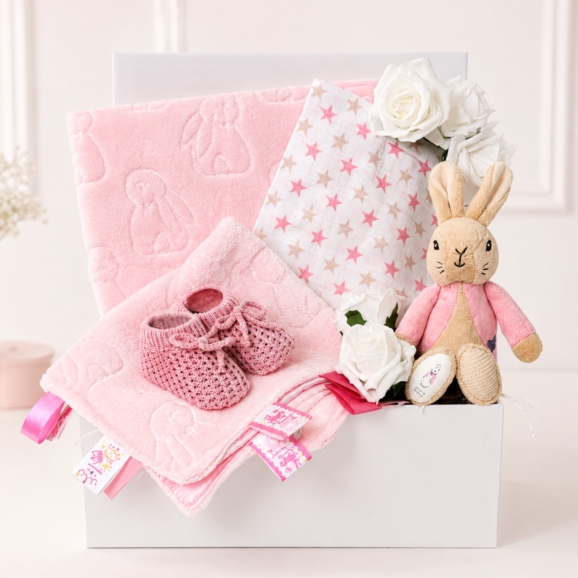Baby girl gift box with Flopsy Bunny, pink blankets and knitted booties.