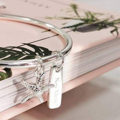 Silver bangle with starfish and rectangular charm 
