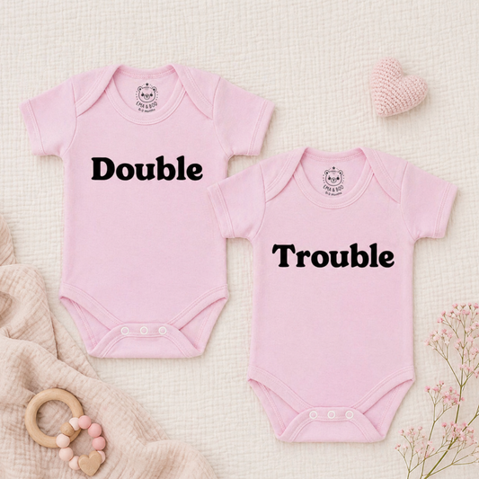 Pink twin baby bodysuits with “Double” and “Trouble” slogans – newborn twin gift sets
