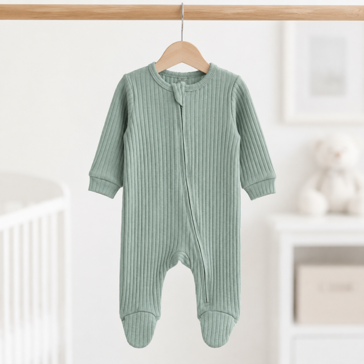 A soft ribbed baby sleepsuit in a beautiful muted sage green shade.