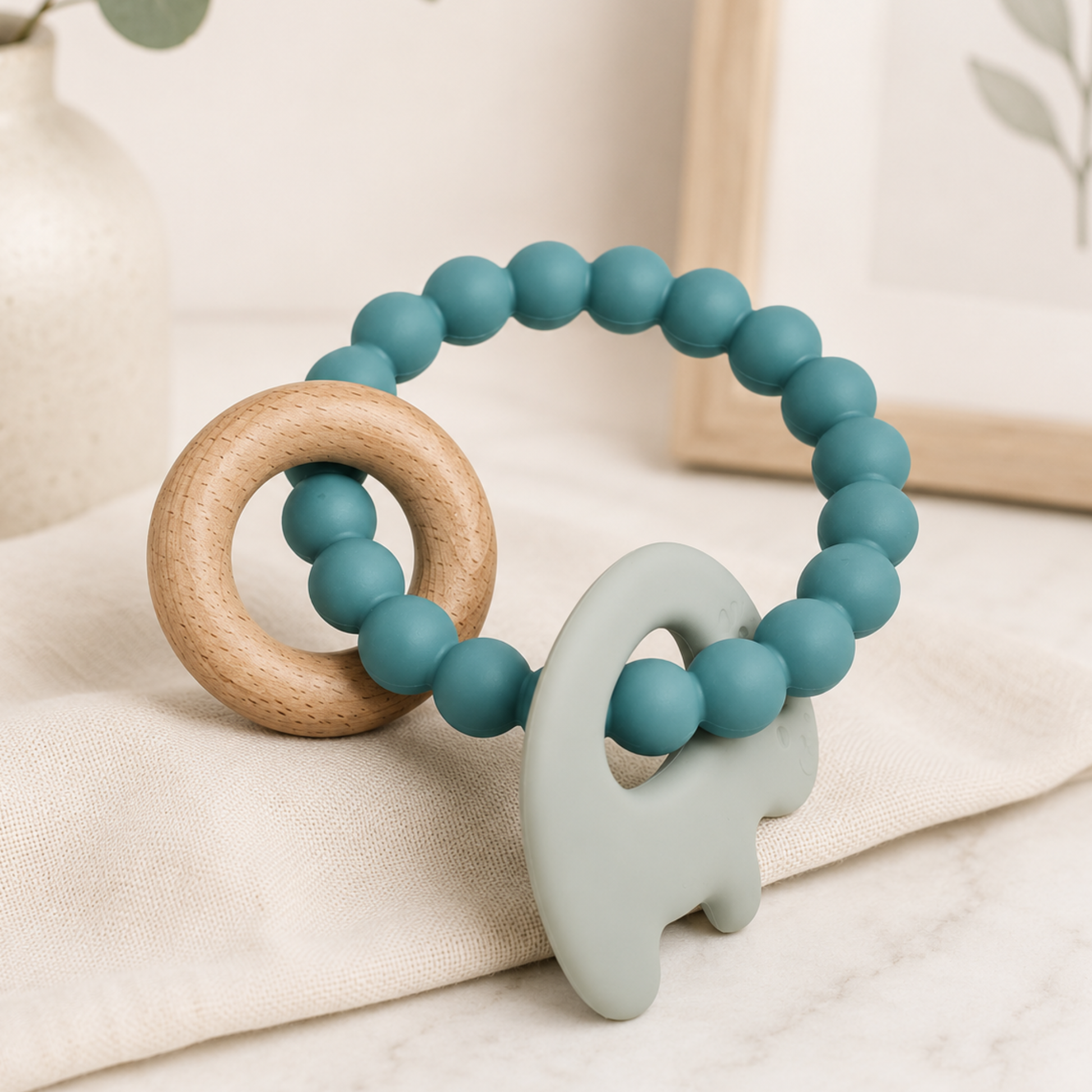 Teething ring with teal beads, wooden ring, and animal-shaped silicone piece 