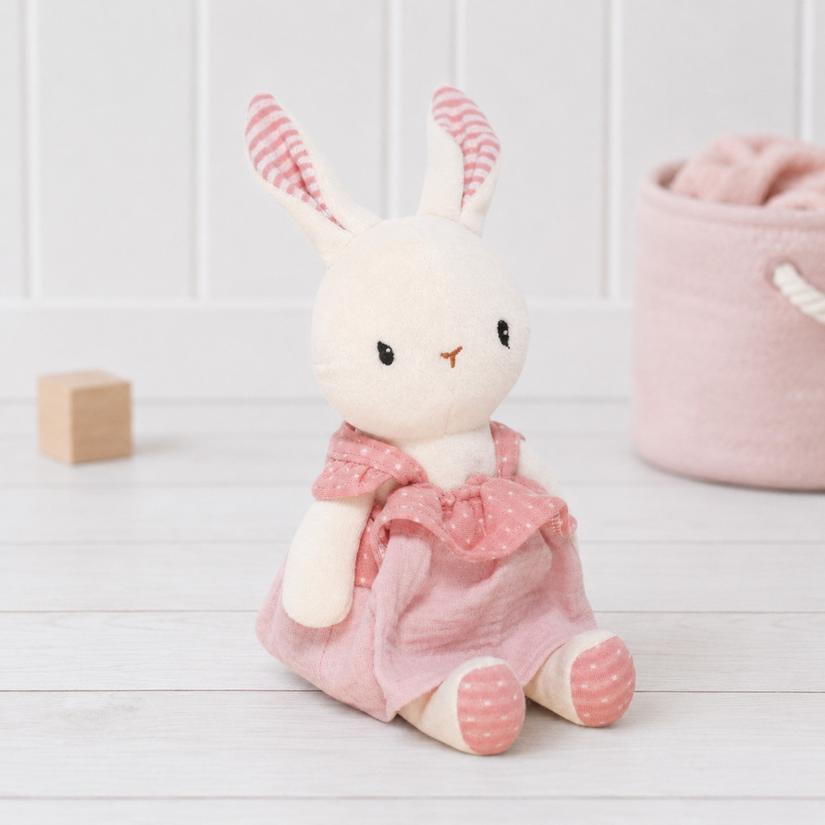 Small white rabbit organic cotton velour baby soft toy wearing a pink dress