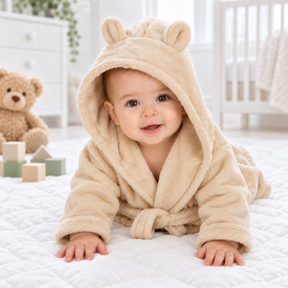 Baby wearing a soft beige hooded dressing gown with teddy bear ears and matching belt
