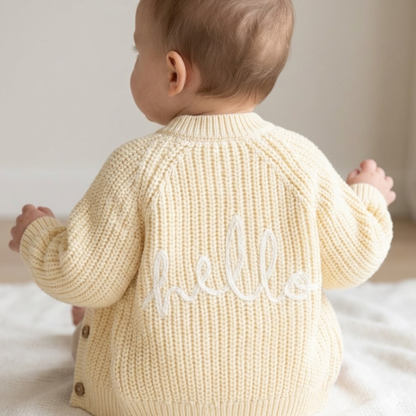 baby girl buttermilk yellow knitted cardigan with hello embroidery on the back by Ema and Boo