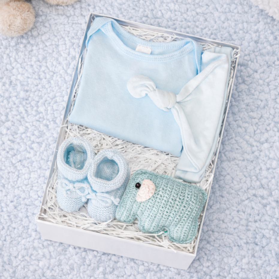 baby boy gift set with blue cotton bodysuit knotted hat knitted booties and elephant rattle