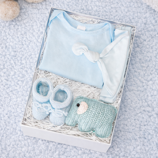 baby boy gift set with blue cotton bodysuit knotted hat knitted booties and elephant rattle